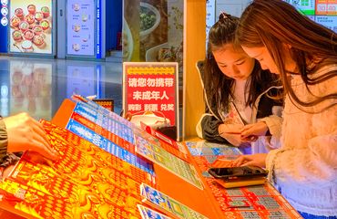 Young people buying scratch lotto tickets in Foshan