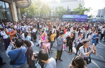 Young people playing a game together on their phones